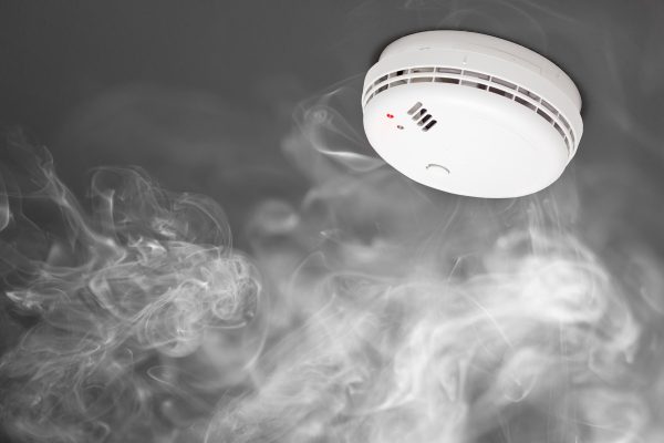 white smoke alarm with smoke in the air